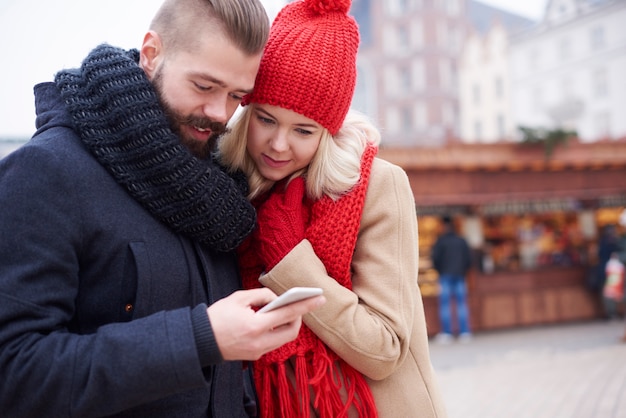 Looking at mobilephone on christmas market