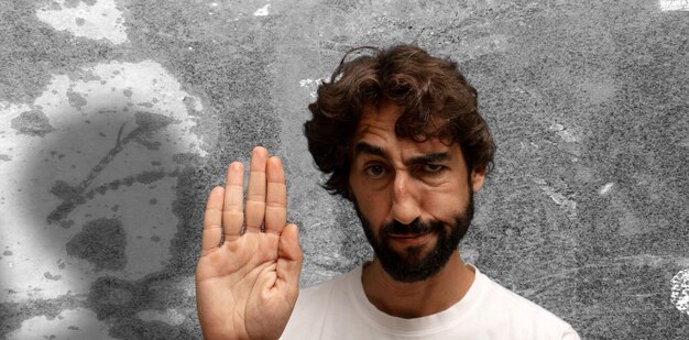 looking serious stern displeased and angry showing open palm making stop gesture