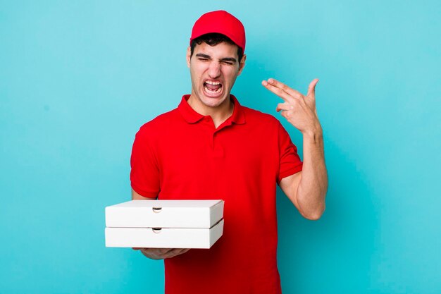 Looking unhappy and stressed suicide gesture making gun sign