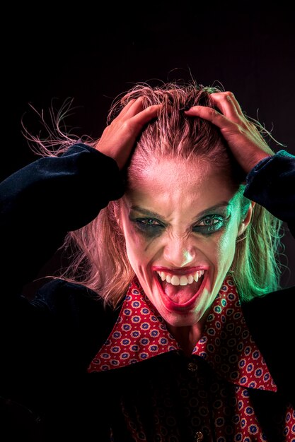 Loony woman holding her head with hands for photo shooting