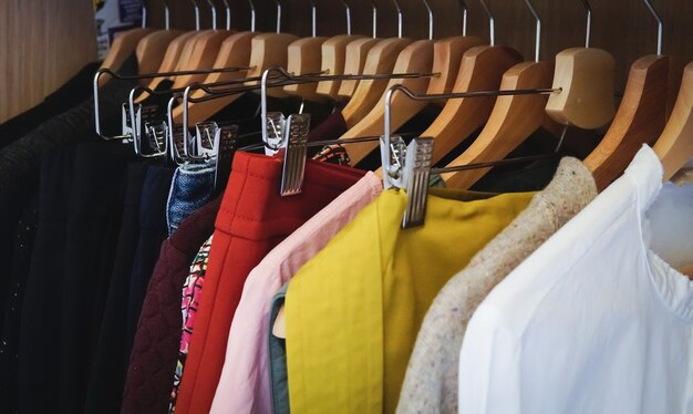 Lot of different clothes hanging in a wardrobe