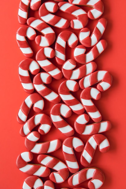 Free photo a lot of gingerbread candy cane shaped cookies flat lay