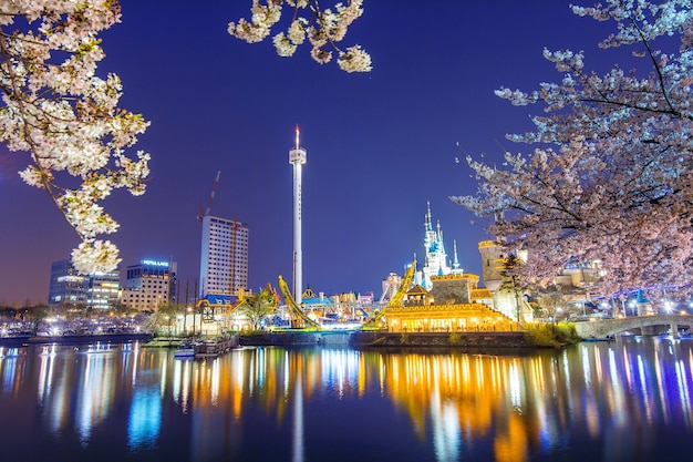 Free photo lotte world amusement park at night and cherry blossom