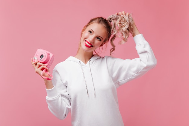 Lovable woman with cheerful smile holding front