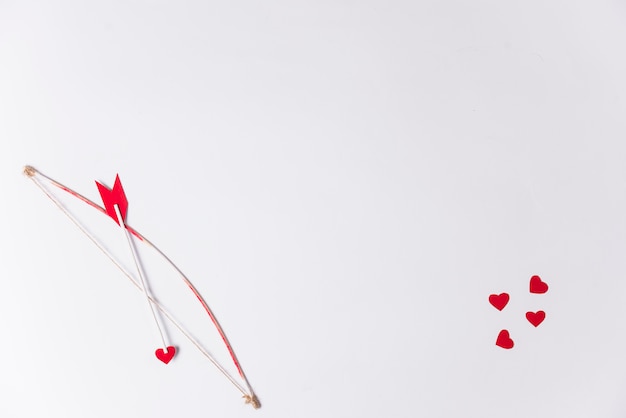 Love arrow with bow on table 