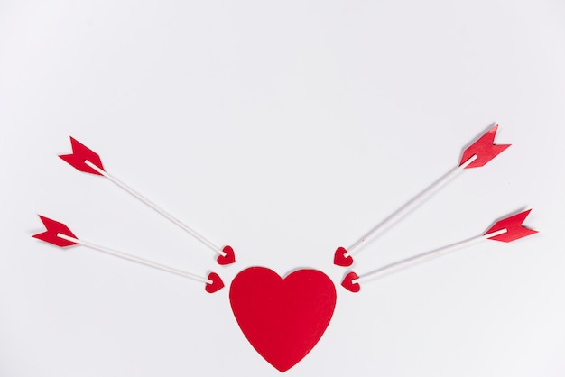 Foto gratuita frecce di amore che mirano al cuore rosso