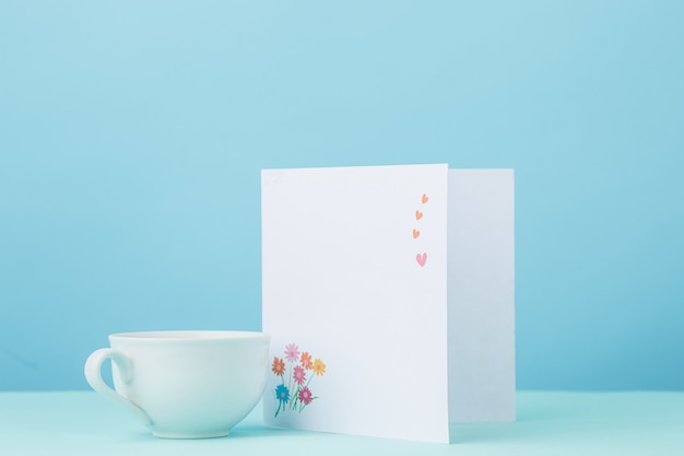 Love background with card and cup gift on table