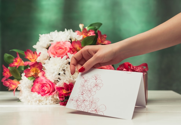 Love background with pink roses, flowers, gift on table