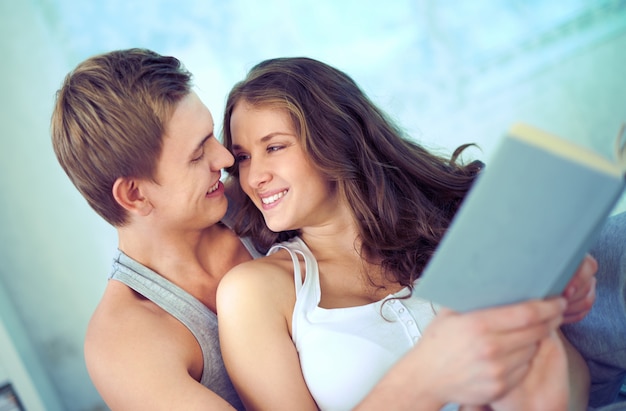 In love couple reading a book together