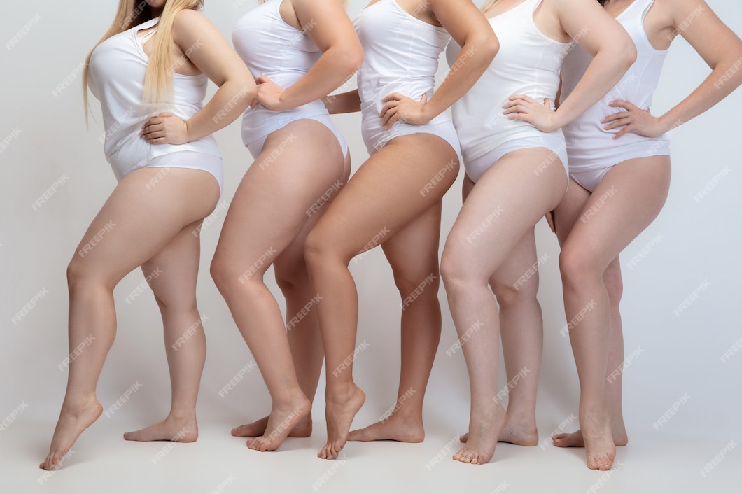 plus size young women posing on white