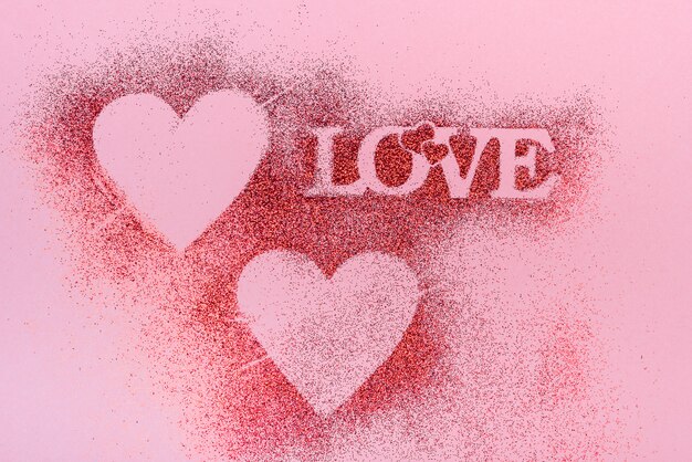 Love inscription from glitter powder on table 