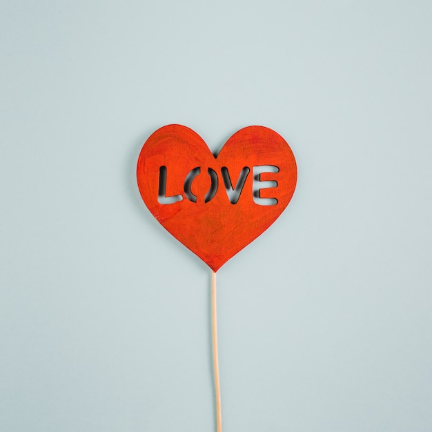 Love inscription on paper heart on stick