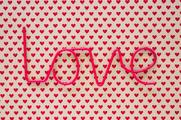 Free photo love inscription on table with heart pattern