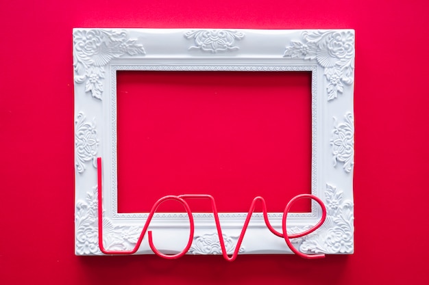 Free photo love inscription with frame on table