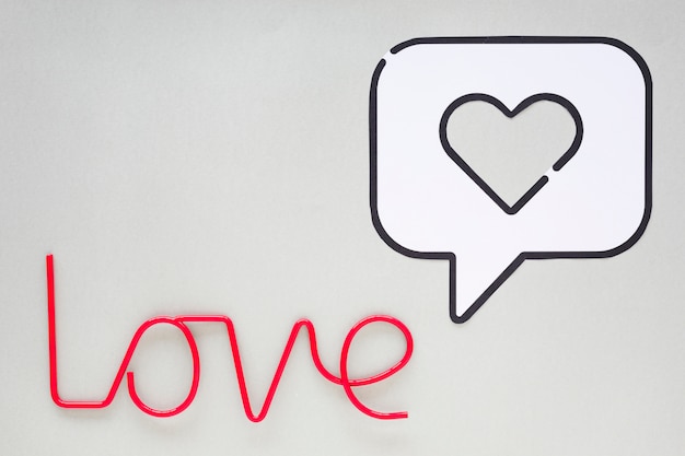 Love inscription with heart in bubble speech icon