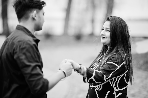 Love story of indian couple posed outdoor holding hands together