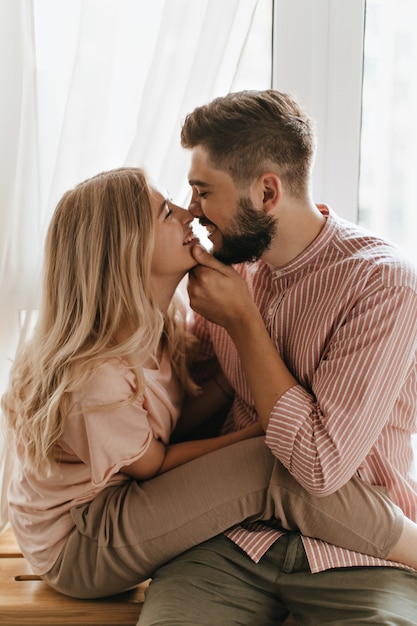 Free photo love story of young couple. man and woman are touching each other with their noses.