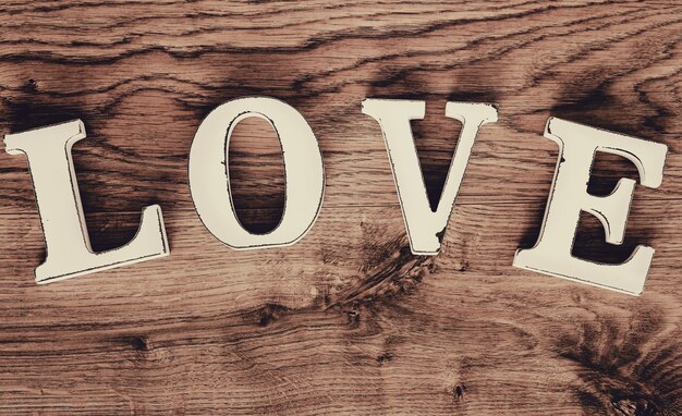 Love text, vintage wooden letters top view