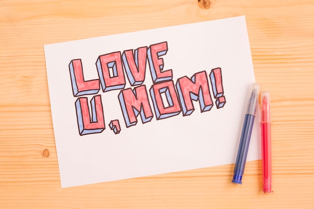 Love u mom paper card on wood 