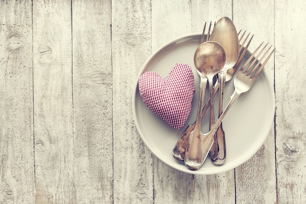 Love, valentine's day or eating concept with vintage cutlery, pl