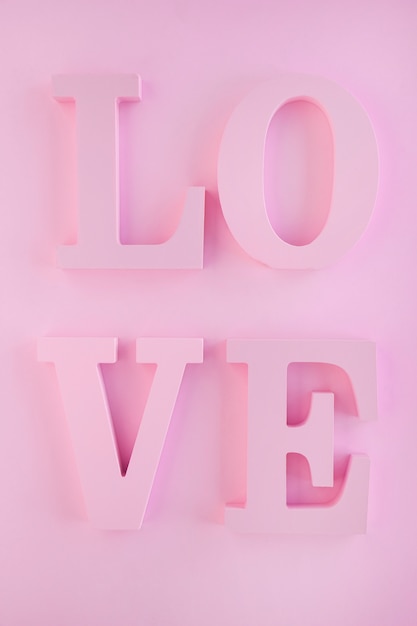 Free photo love writing on pink wall