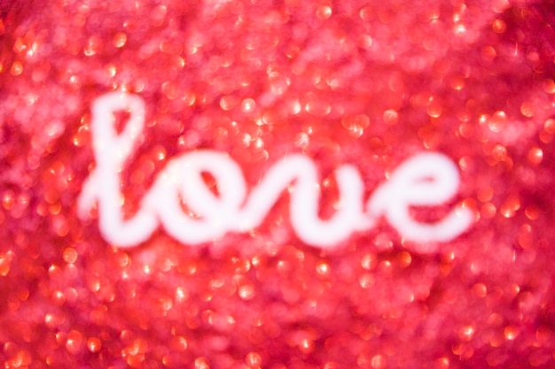 Free photo love writing on red glitter