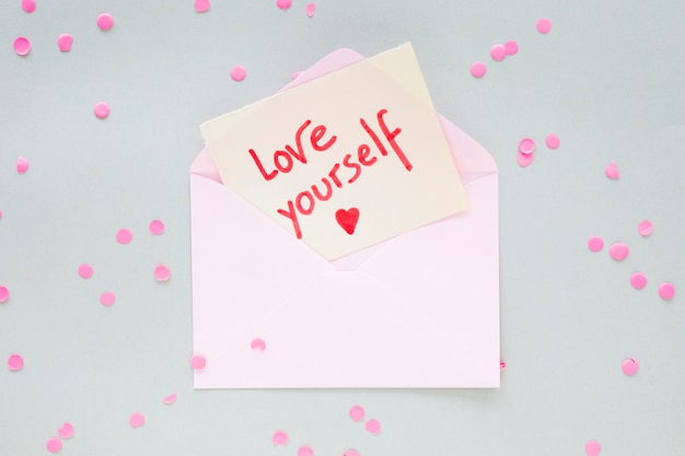 Free photo love yourself inscription on paper in envelope