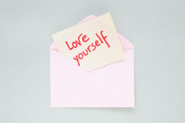 Free photo love yourself inscription on paper in light envelope