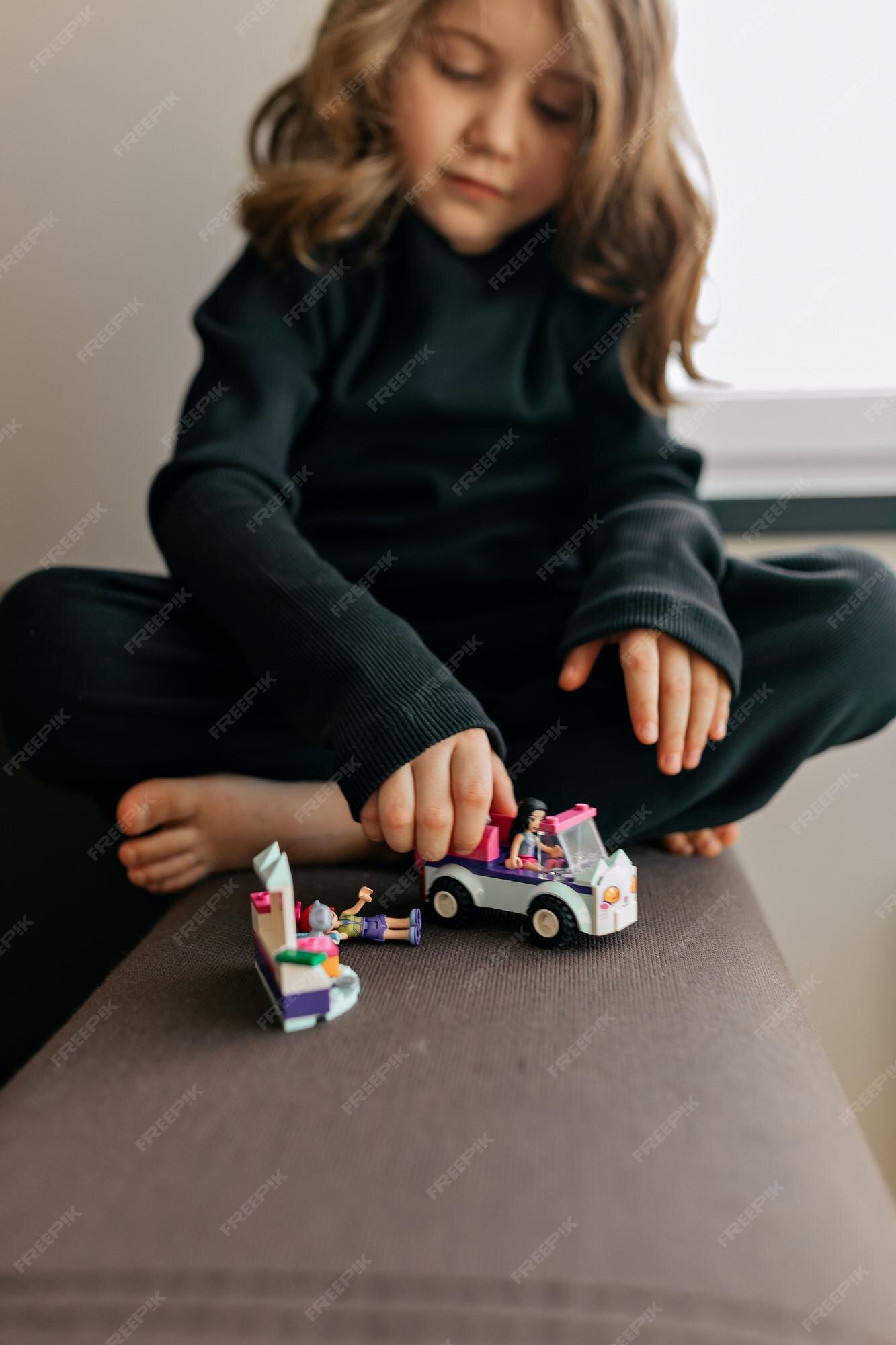 Free Photo | Lovely adorable pretty girl with wavy hairstyle is playing  with toys at home adorable little girl is playing with cars creative games  for kids staying at home during lockdown
