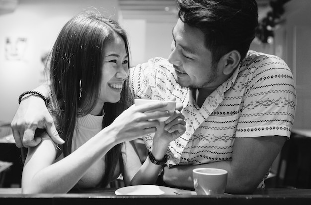 Lovely asian couple having coffee