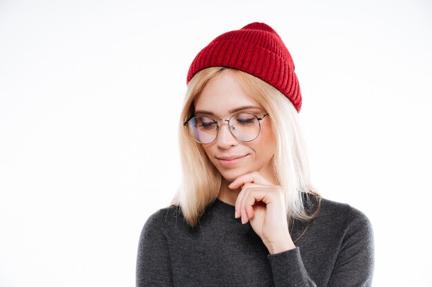 Lovely blonde woman in hat and glasses looking away