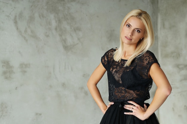 Lovely blonde woman portrait with dress with transparencies