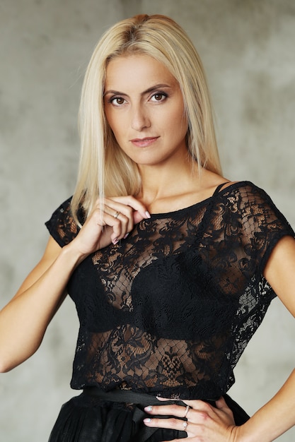 Lovely blonde woman portrait with dress with transparencies