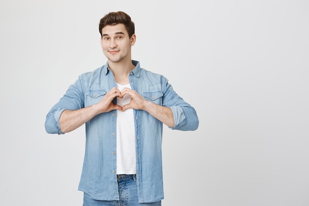 Lovely boyfriend show heart gesture and smiling