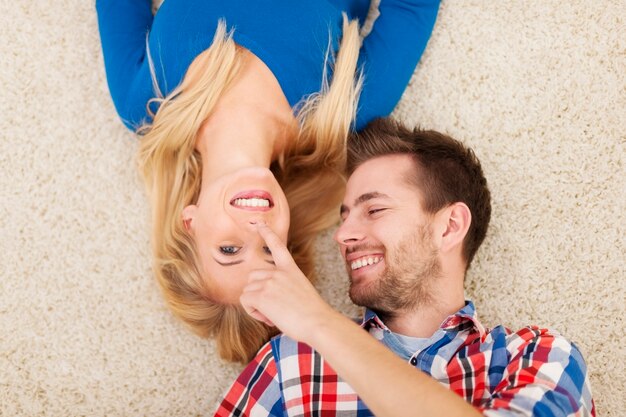 Lovely couple flirting on carpet