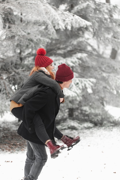 Lovely couple fooling around in the snow sideways