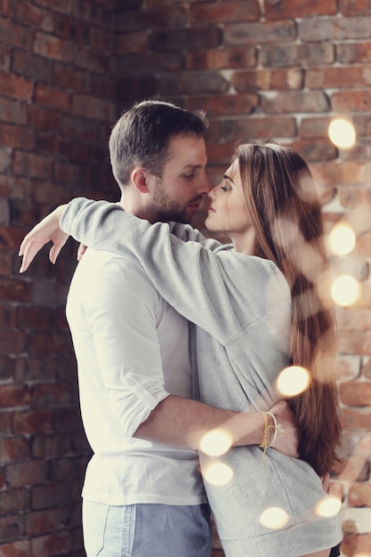 Lovely couple hugging at home hugging