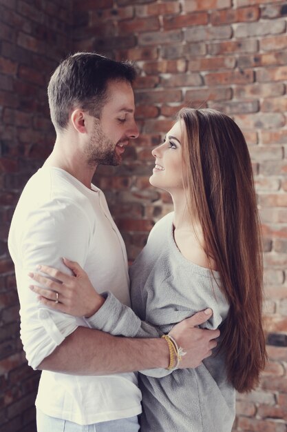 Lovely couple hugging at home