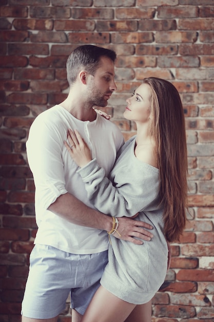 Lovely couple hugging at home