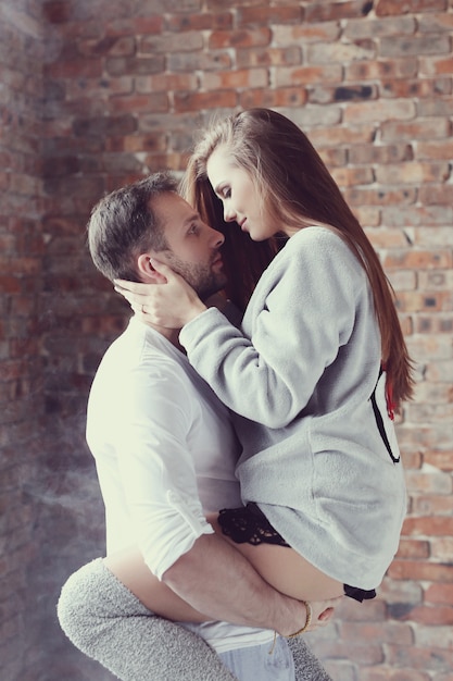 Lovely couple hugging at home