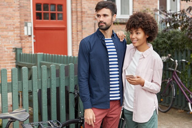 Lovely couple look happily into distance