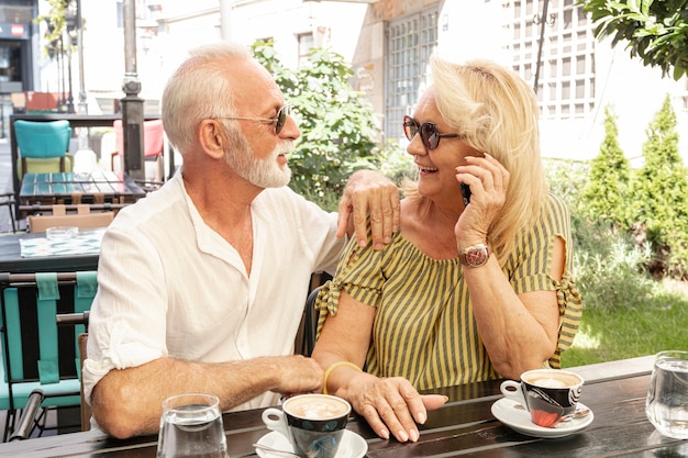 Free photo lovely couple looking at each other by a table