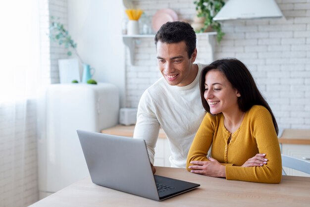 Lovely couple looking at laptop