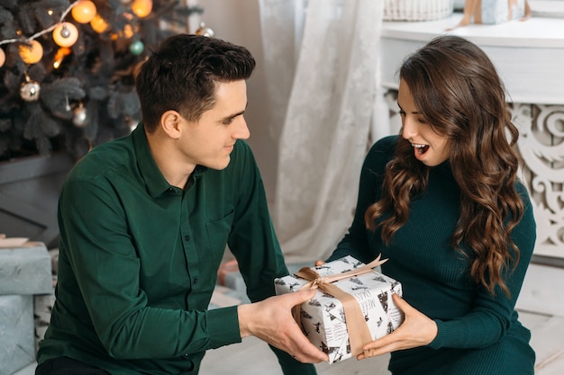 Lovely couple in love admiring present