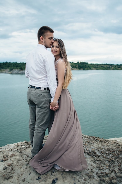 The lovely couple in love embarcing near river