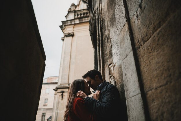 The lovely couple in love embracing near cathedral