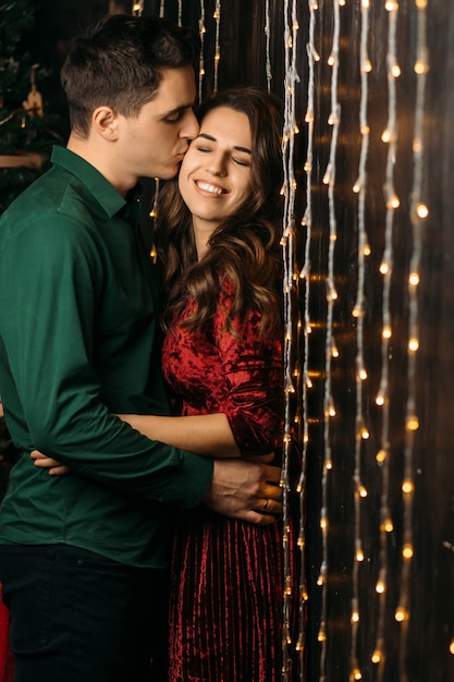 The lovely couple in love embracing near lamps