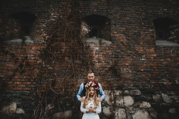 The lovely couple in love standing near building