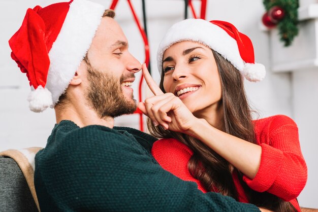 Free photo lovely couple playing tricks on sofa