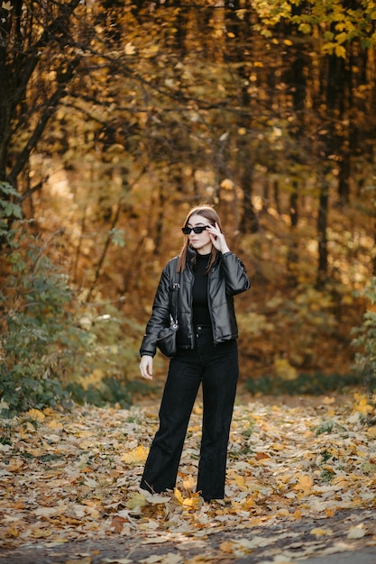 Free photo lovely couple posing in autumn forest, lovers walking in park